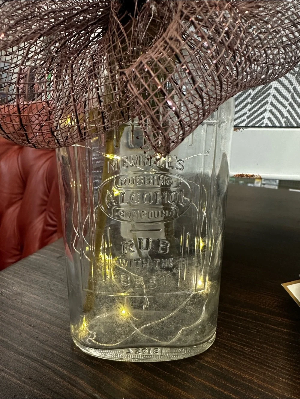 Fall Floral Arrangement up cycled old rubbing alcohol bottle with twinkle lights